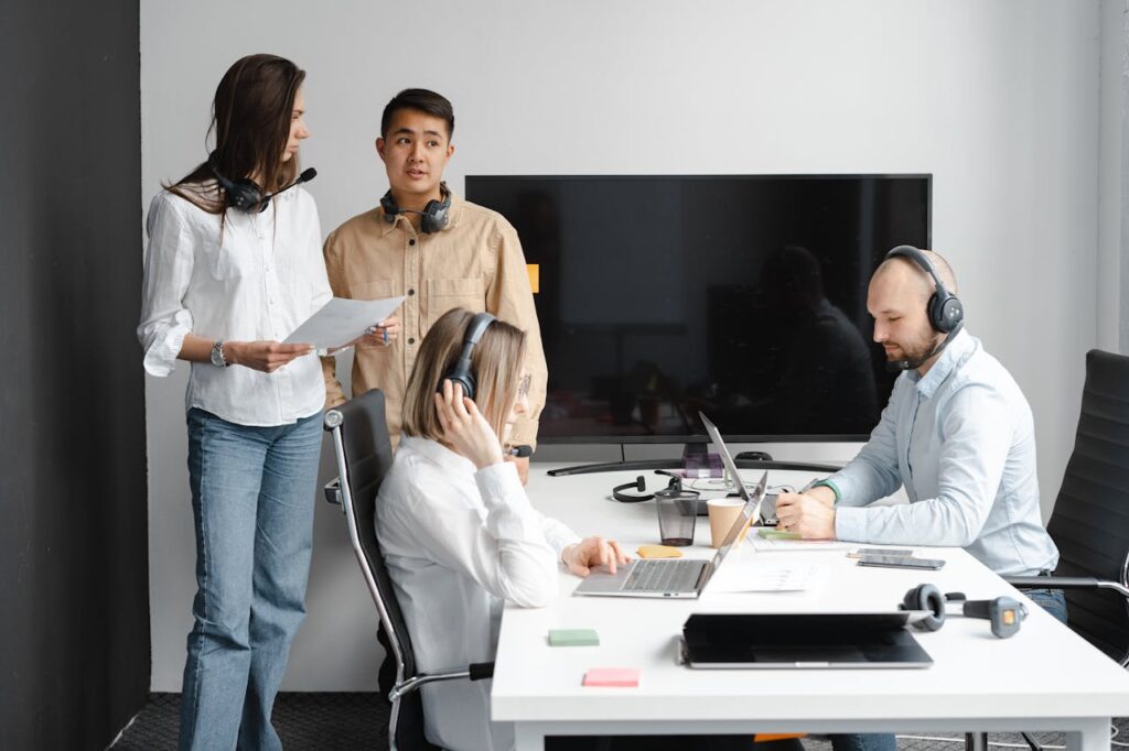 Group of call center agents working together in a modern office setting.
